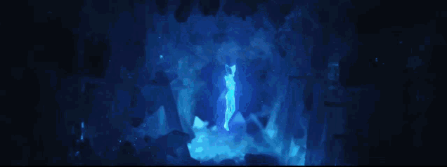 a person is standing in a dark room with a blue light behind them