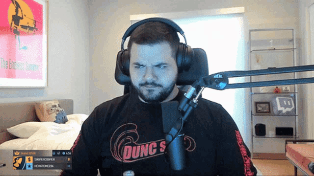 a man wearing headphones and a shirt that says dunc 's
