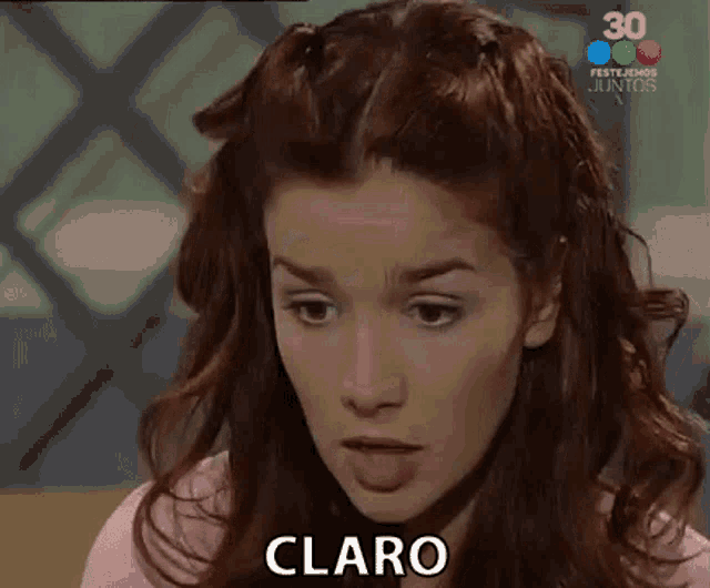 a close up of a woman 's face with the word claro in the corner