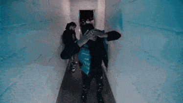 a blurred image of a person walking in a dark room with a blurry background