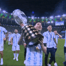 a soccer player holding a trophy with the number 16 on his jersey