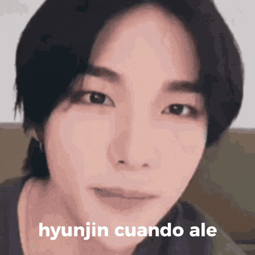 a close up of a person 's face with the words hyunjin cuando ale written on it