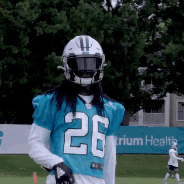a football player wearing a blue jersey with the number 26