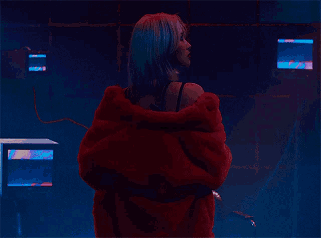 a woman with blue hair wearing a red coat