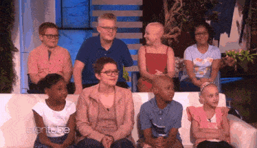 a group of children are sitting on a couch with the ellentube logo on the bottom