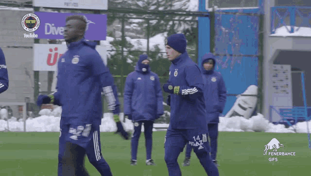 a group of soccer players are running on a field in front of a youtube banner