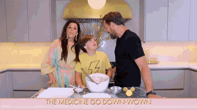 a family in a kitchen with the words the medicine go down wown