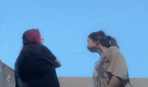 a woman is touching another woman 's forehead with her hand
