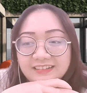 a close up of a woman wearing glasses and earphones .