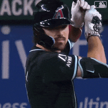 a baseball player with the letter a on his helmet is swinging at a ball