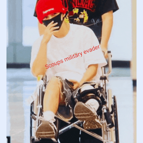 a person in a wheelchair with the words " scoups military evader " on it
