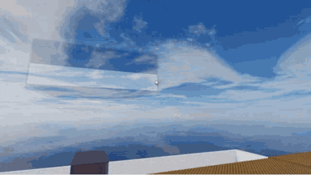 a computer generated image of a blue sky with clouds and a building in the foreground
