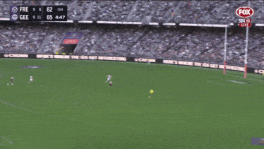 a man kicking a ball on a soccer field with a fox logo in the corner
