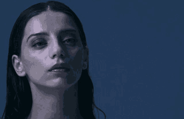 a close up of a woman 's face with her eyes closed