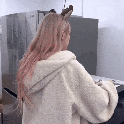 a woman standing in front of a fridge that says lg on it