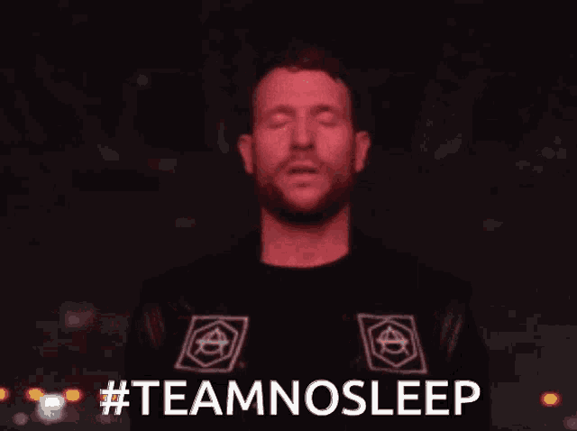 a man with his eyes closed is wearing a black shirt and a leather jacket and says teamnosleep .