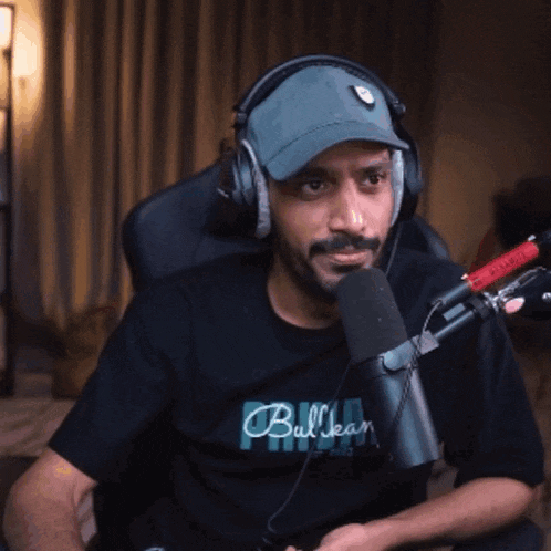 a man wearing headphones and a black shirt that says bulleany