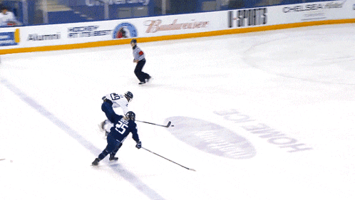 a hockey player with the number 5 on his jersey stands on the ice