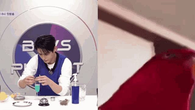 a man in a blue vest is making a drink in front of a sign that says ' boys ' on it
