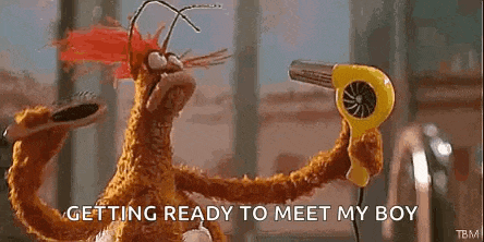 a stuffed animal is holding a yellow hair dryer in its hand .