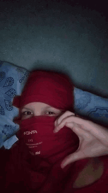 a person wearing a red hoodie that says nova