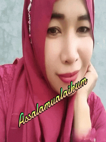 a woman wearing a pink hijab with the words assalamualaikum written on her face