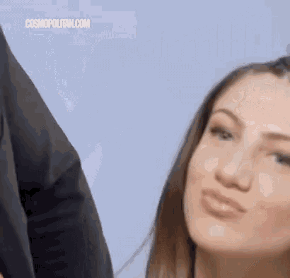 a close up of a woman making a funny face with her mouth open .