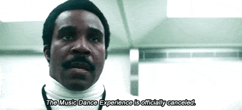 a man with a bandage on his neck is talking about the music dance experience being officially canceled .