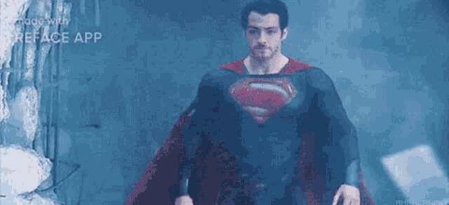 a man in a superman costume is standing in front of a building .