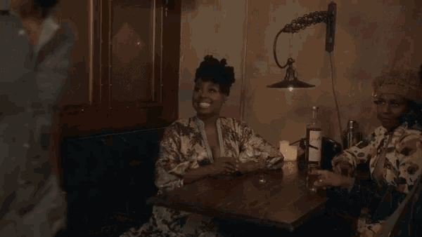 a woman sitting at a table with a man and a candle