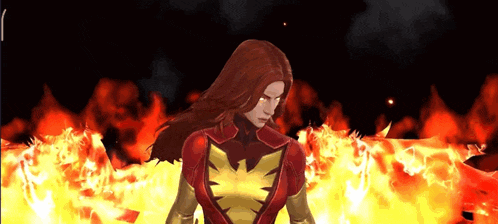 a woman in a phoenix costume stands in front of a fire background