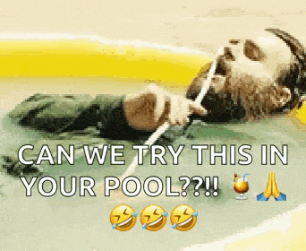 a man with a beard is laying in a pool with a straw in his mouth