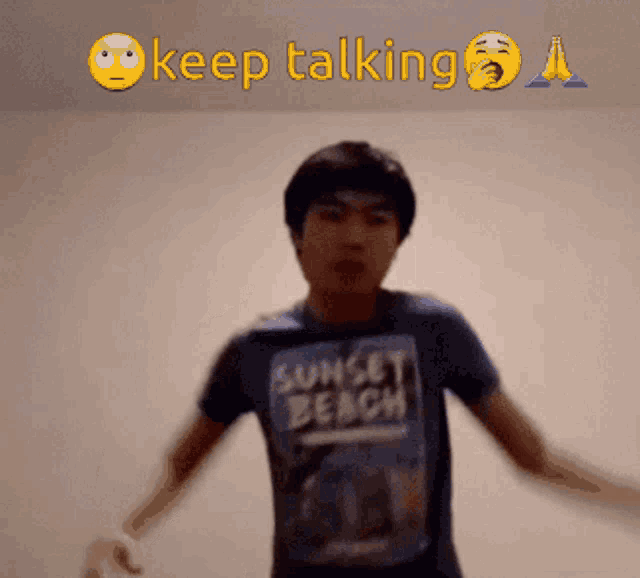 a man wearing a sunset beach shirt is talking