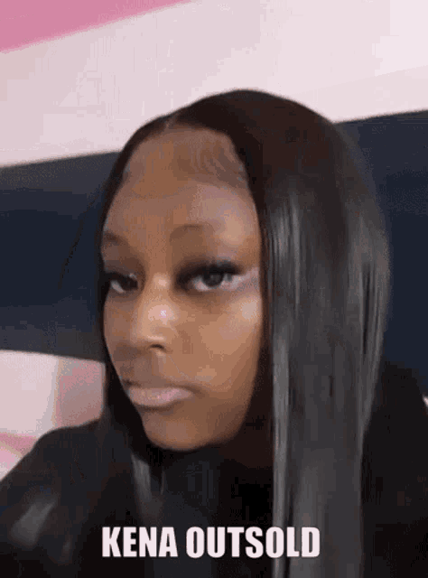 a woman with long black hair is making a funny face with the words `` kena outsold '' written next to her .