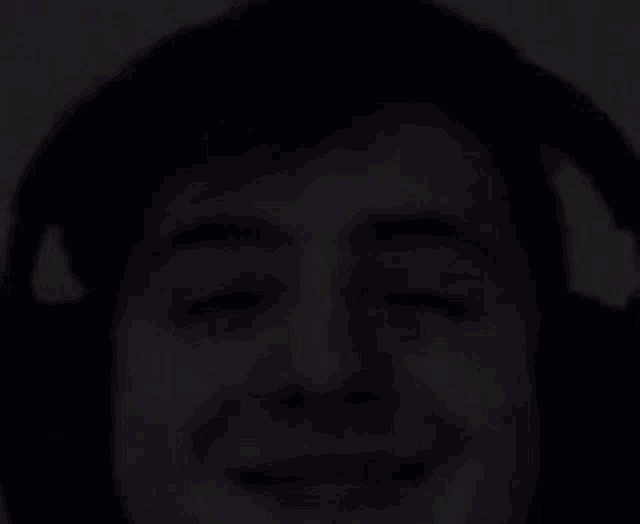 a close up of a young man wearing headphones and smiling .