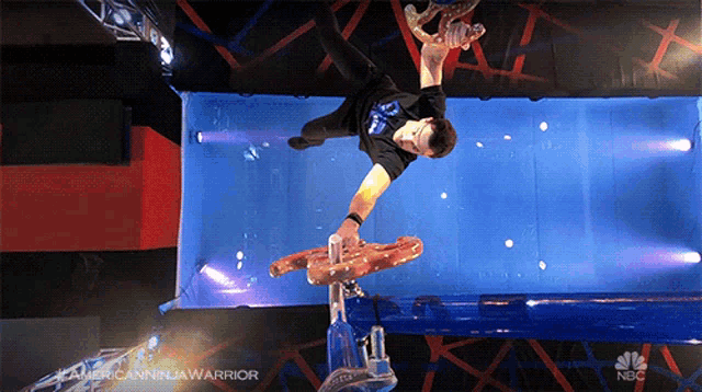 a man is doing a trick in a nbc advertisement for american ninja warrior