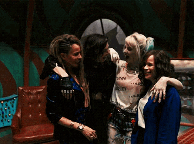 a group of women are posing for a picture with harley quinn