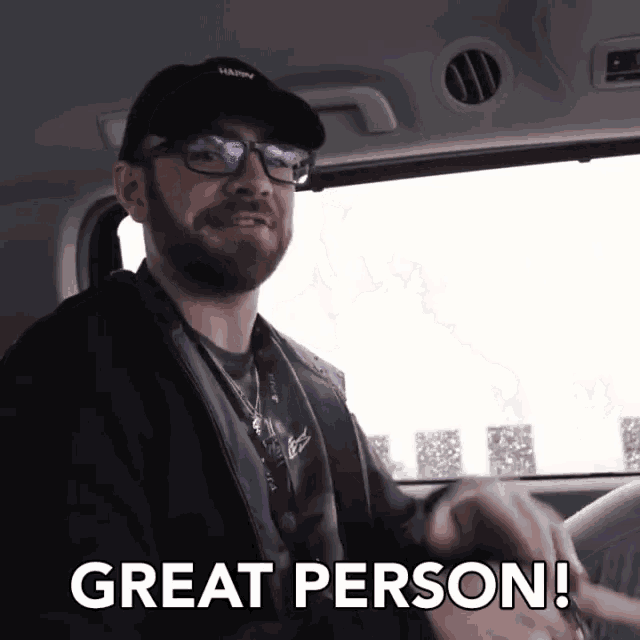 a man wearing glasses and a hat that says happy on it