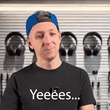 a man wearing a blue hat and a black shirt says yeeees