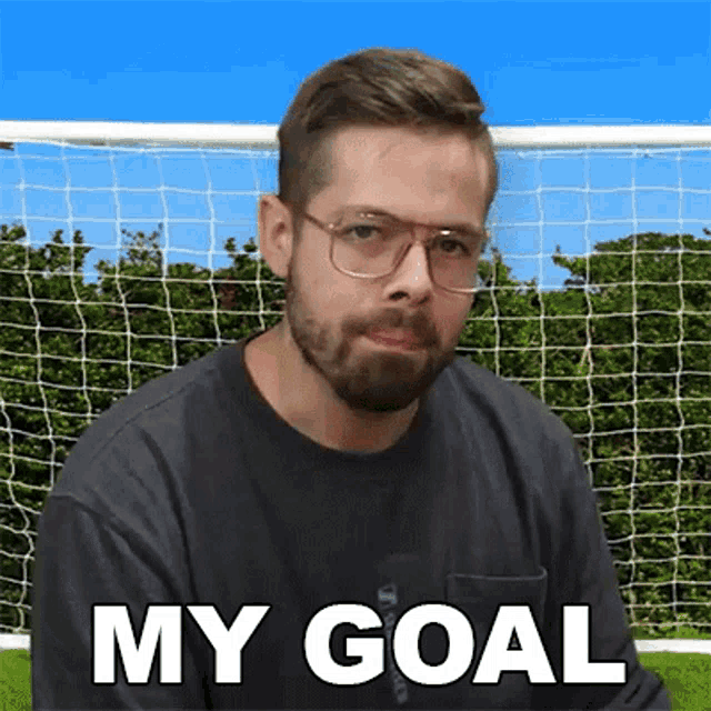 a man with glasses and a beard says " my goal "