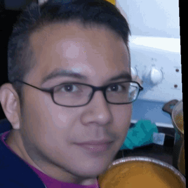 a close up of a man 's face with glasses
