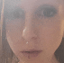 a close up of a woman 's face with a nose ring on it .