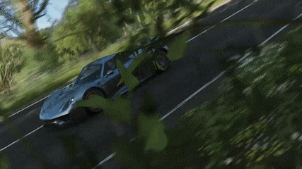 a porsche 918 spyder is driving down a road next to a car .
