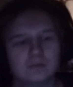 a close up of a person 's face with a dark background