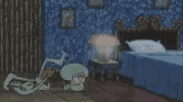 a person is laying on a bed in a bedroom with a blue blanket and a blue wall .