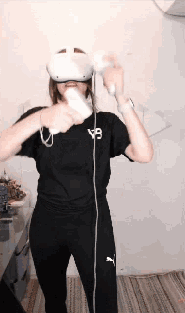a woman wearing a virtual reality headset is holding a wii remote