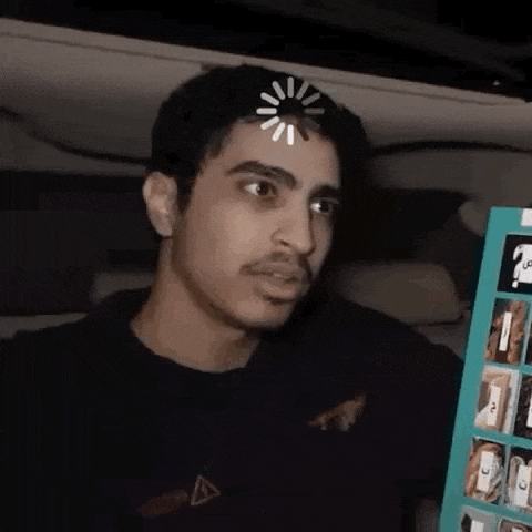 a man with a loading bar on his forehead is holding a cardboard box .