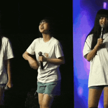 a girl singing into a microphone wearing a shirt that says ' opera ' on it