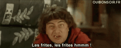 a man in a red jacket is saying les frites , les frites hmmm !