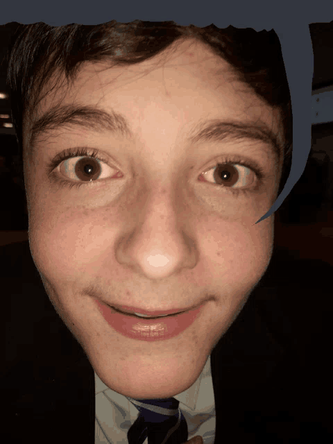 a close up of a boy 's face with a speech bubble in the background